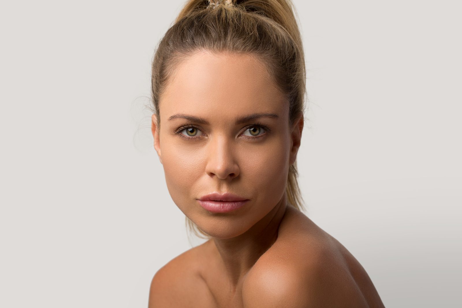 Bare skin headshot on grey