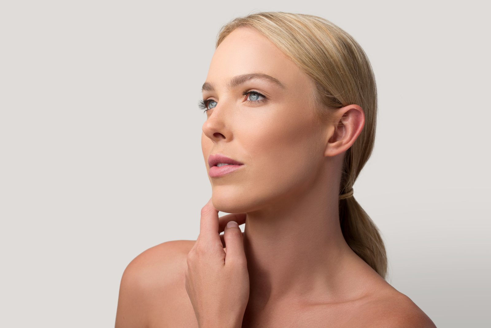 Profile with a hand at the jawline