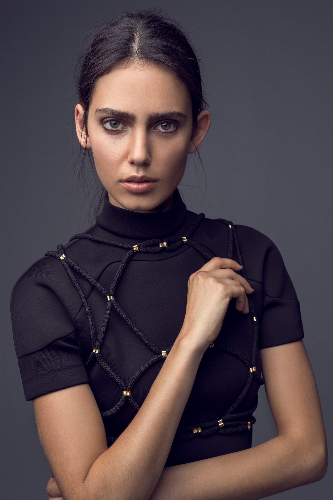 Black neoprene top with rope detail, studio lighting