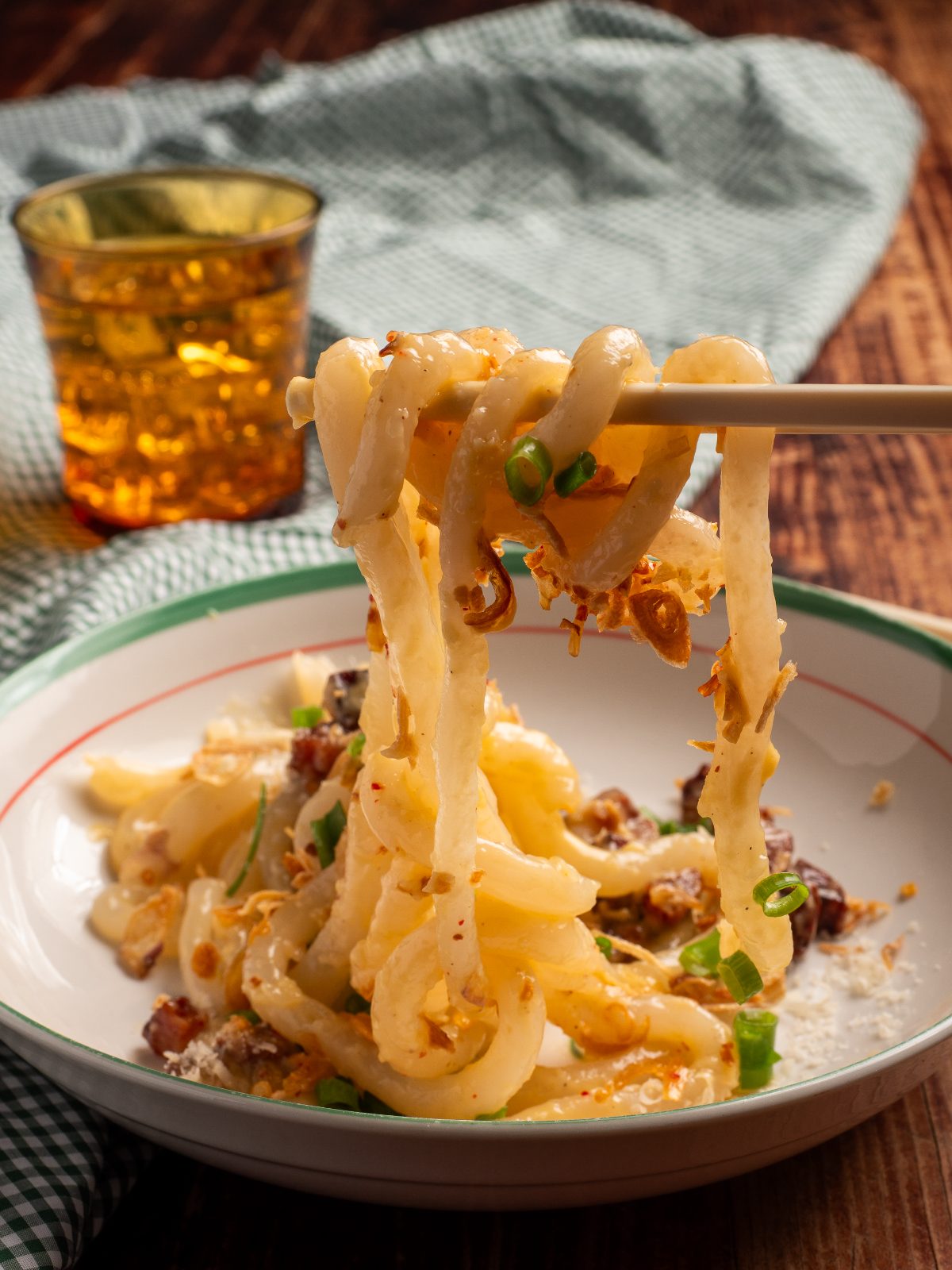 Tapioca noodle carbonara lifted on chopsticks
