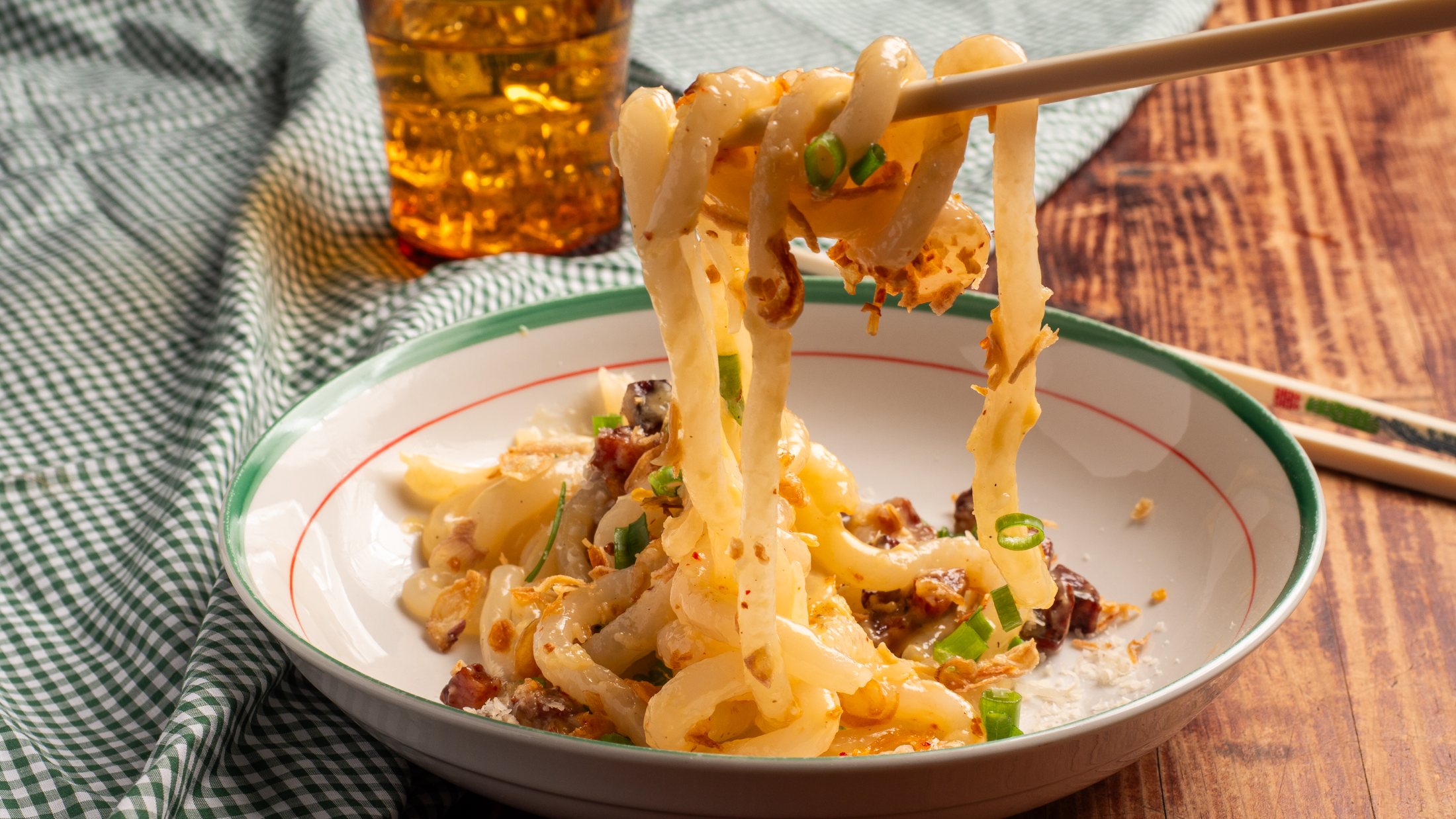 Tapioca noodle carbonara lifted on chopsticks